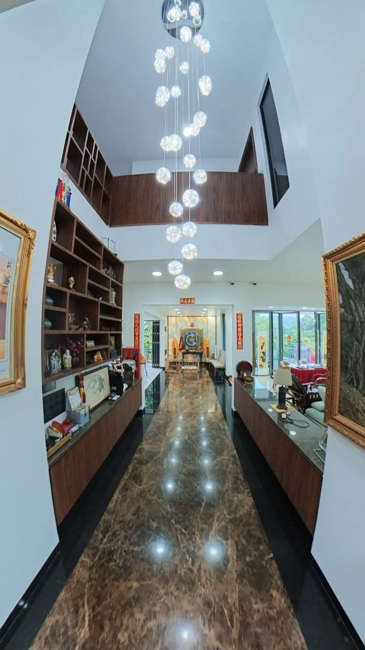 Grand marble hallway with pendant lighting inside the Horizon Hills bungalow